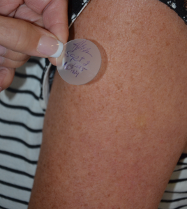 Photo of transdermal patch being applied to an arm