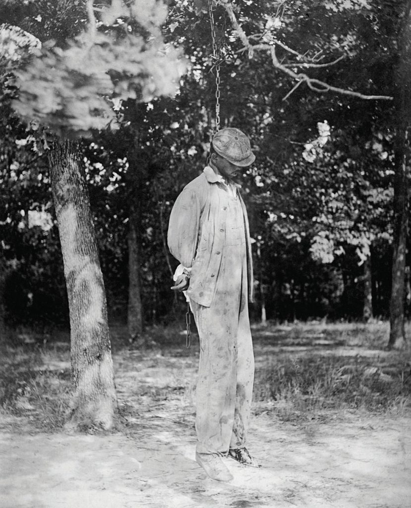An African American man hanging from a noose. A victim of lynching.