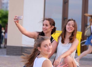 Girls taking a selfie on the street