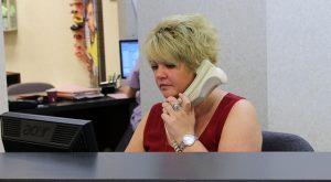 Receptionist answering phone at suburban eye care