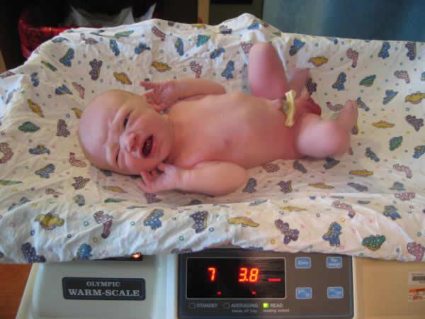 A newborn being weighed