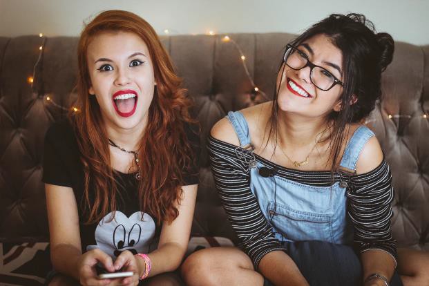 Two smiling teenage women.