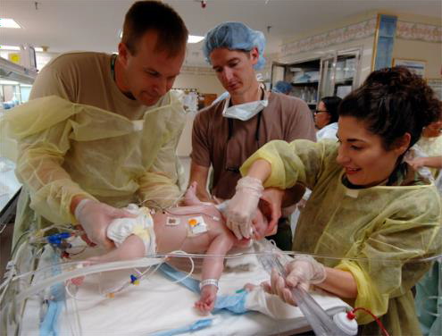 Medical professionals caring for an infant.