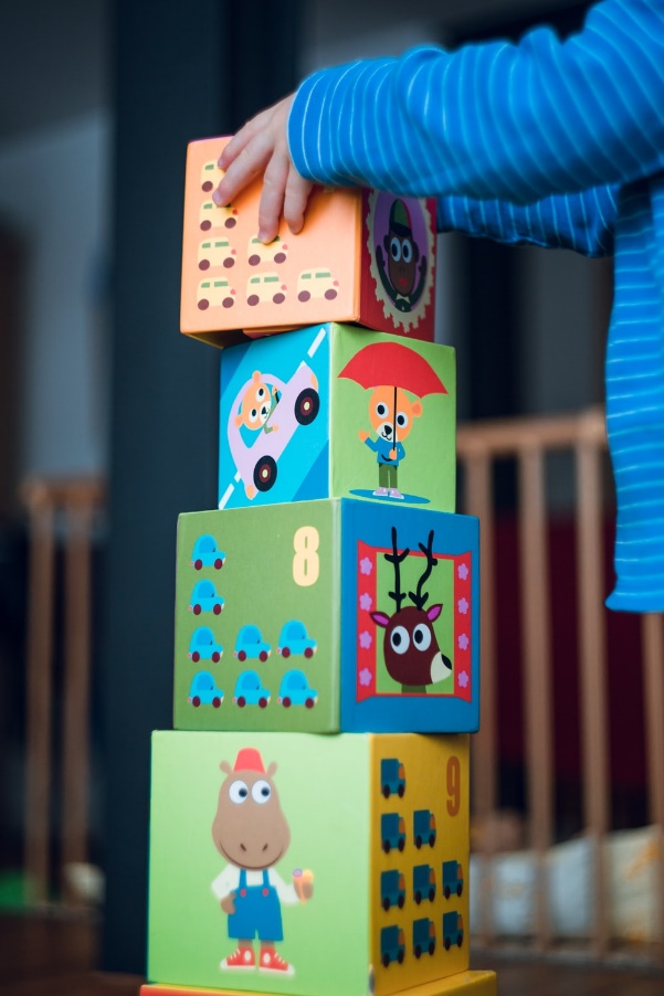A child stacks building blocks.