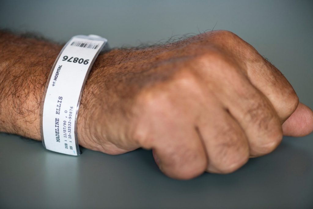 Photo of hand with patient identification bracelet on wrist