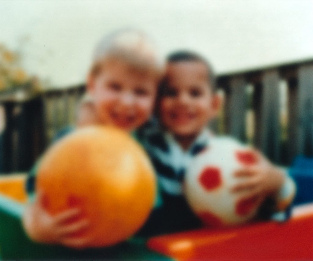 Photo of two young children, blurred to simulate vision with cataracts