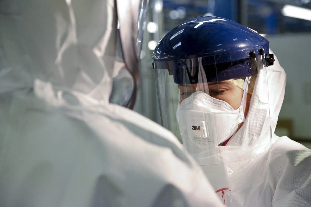 Photo showing person in full PPE facing camera