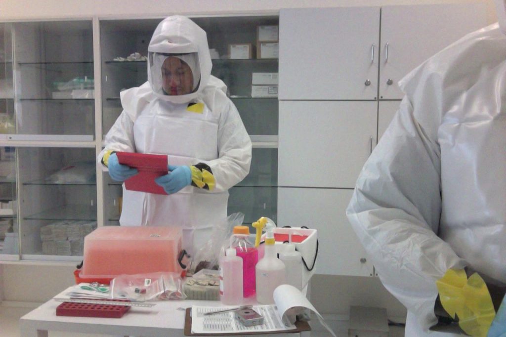 Image showing working wearing Powered Air Purifying Respirator in lab environment