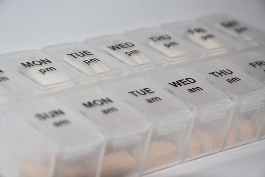 Photo showing a medication box, with labels for days of the week