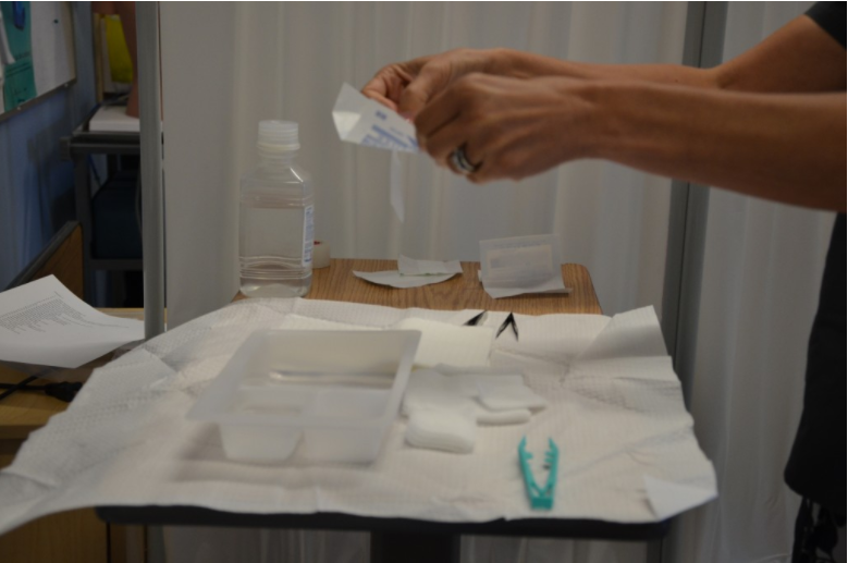 Photo of hands dispensing items on a sterile field