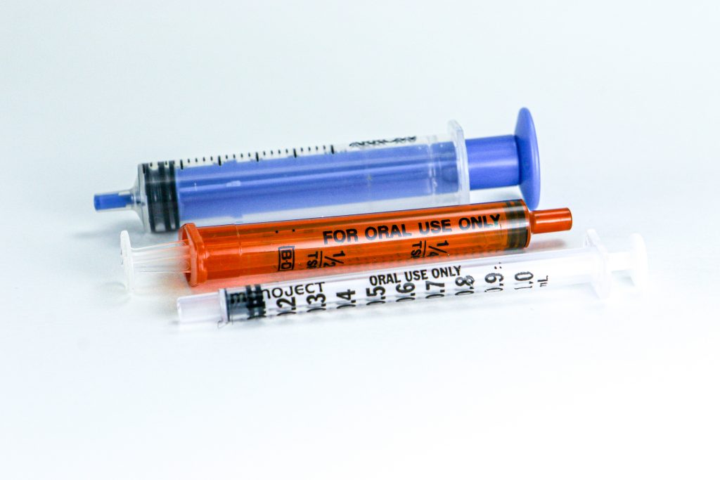 Photo showing closeup of three different sizes of oral syringes