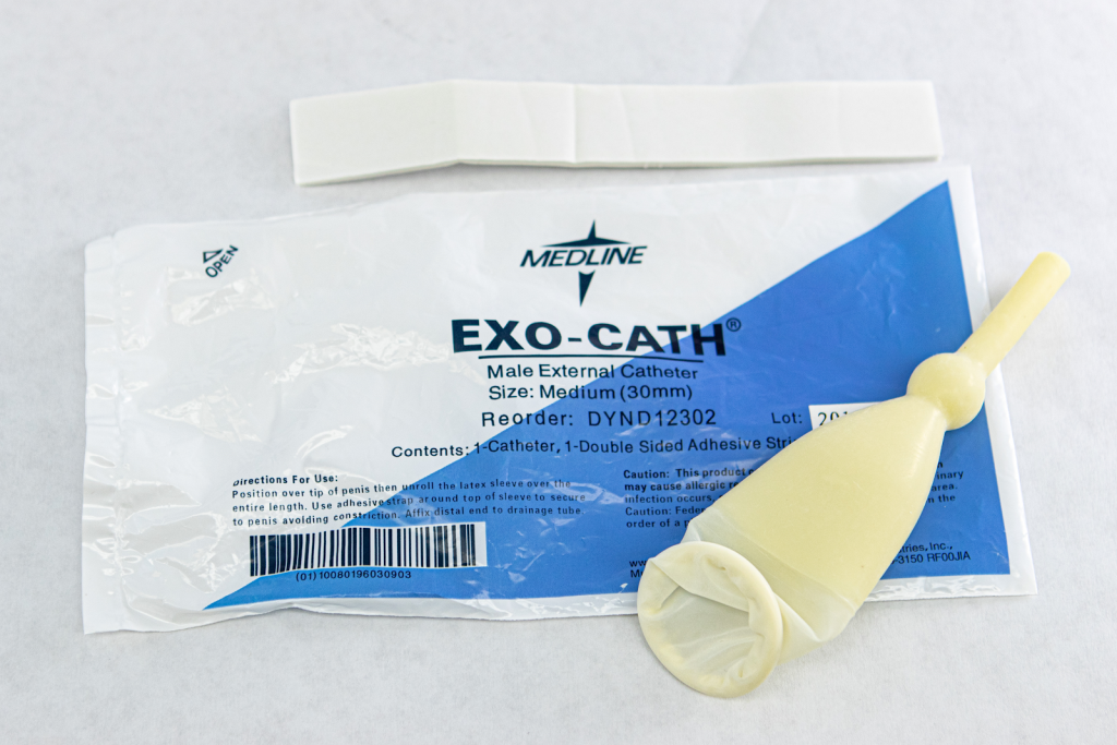 Photo showing condom catheter lying on its packaging