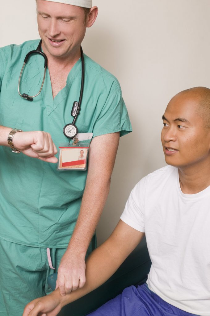 Photo showing nurse checking patient's pulse