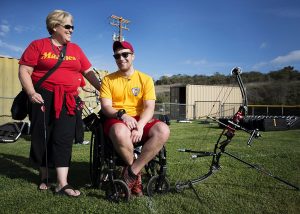 Image showing a woman standing next to a man in a wheelchair