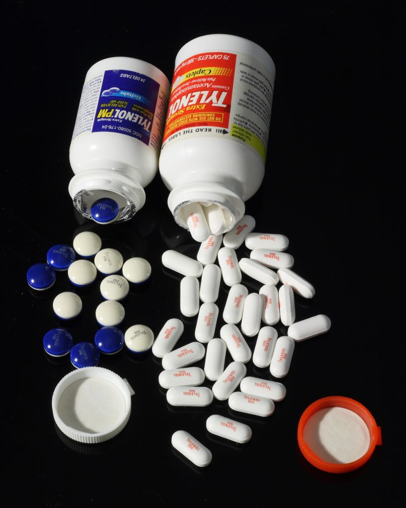 Image showing Acetaminophen (Tylenol) and Acetaminophen with Benadryl (Tylenol PM), with contents spilled out