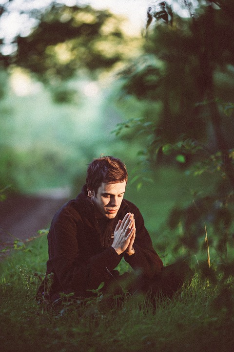 Image showing person praying in wooded area