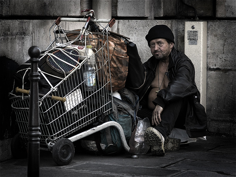 Photo showing a homeless person with their belongings in a cart
