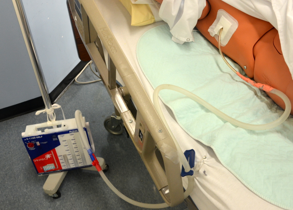 Photo showing a Closed Chest Tube Drainage System attached to a simulated patient