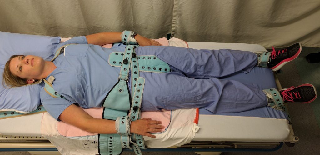 Photo showing simulated patient in restraints