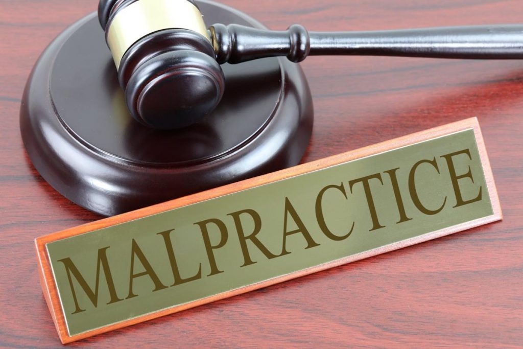 Image showing gavel and a sign reading malpractice