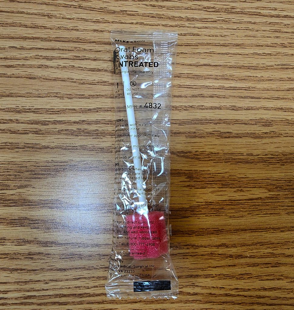 Photo showing an oral swab still inside unopened packaging