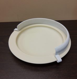 Photo showing a plate guard in place on a plate