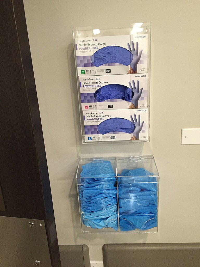 Photo showing wall dispenser with exam glove boxes
