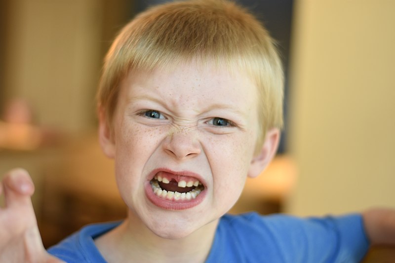 Photo of a young child with an angry facial expression
