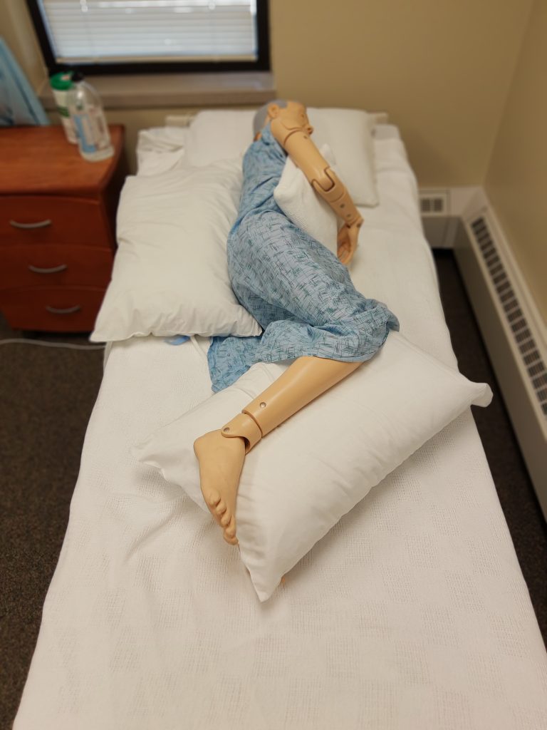 Photo showing a simulated patient in a properly aligned lateral position