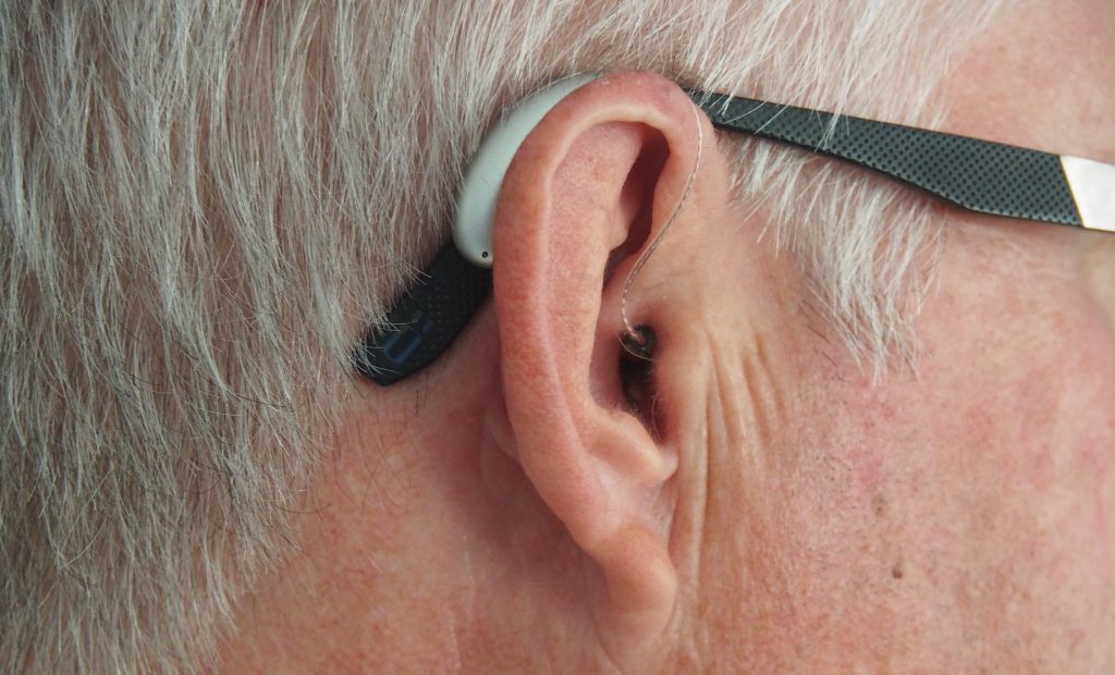 Photo showing Hearing Aid on Top of the Ear