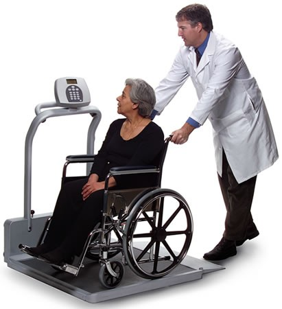 Photo showing a simulated patient and medical worker using a Wheelchair Scale