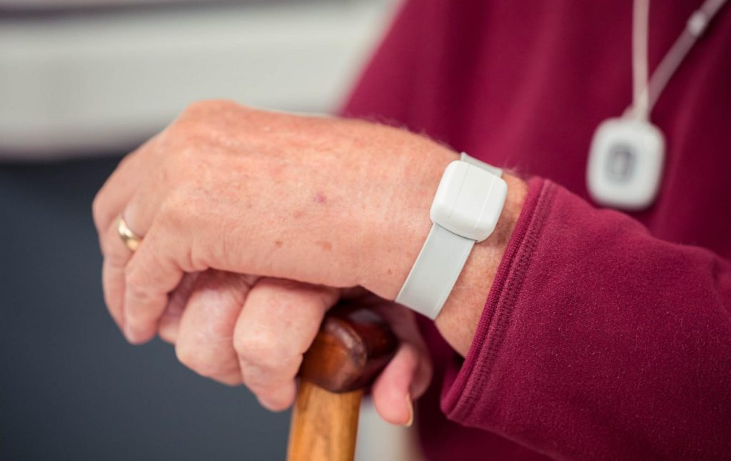 Photo showing a closeup of a wanderguard bracelet on an elderly person's wrist.