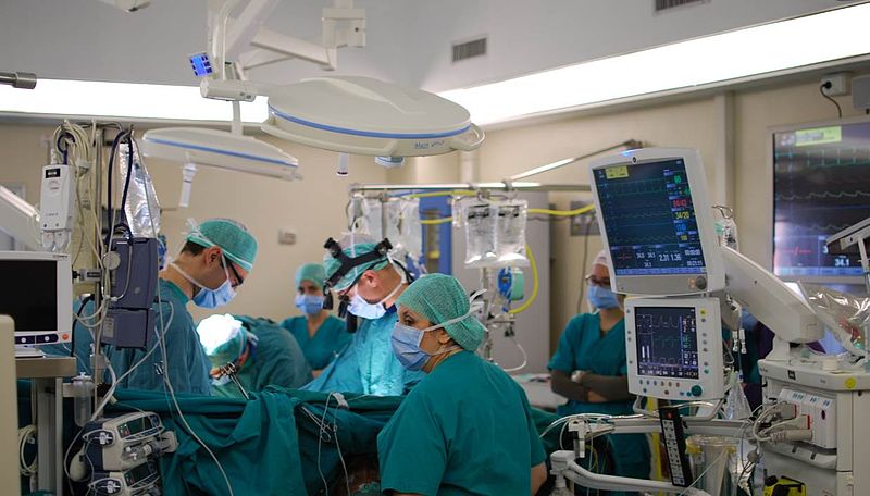 Image showing a cardiac surgery team, surrounded by equipment and monitors, providing interoperative care