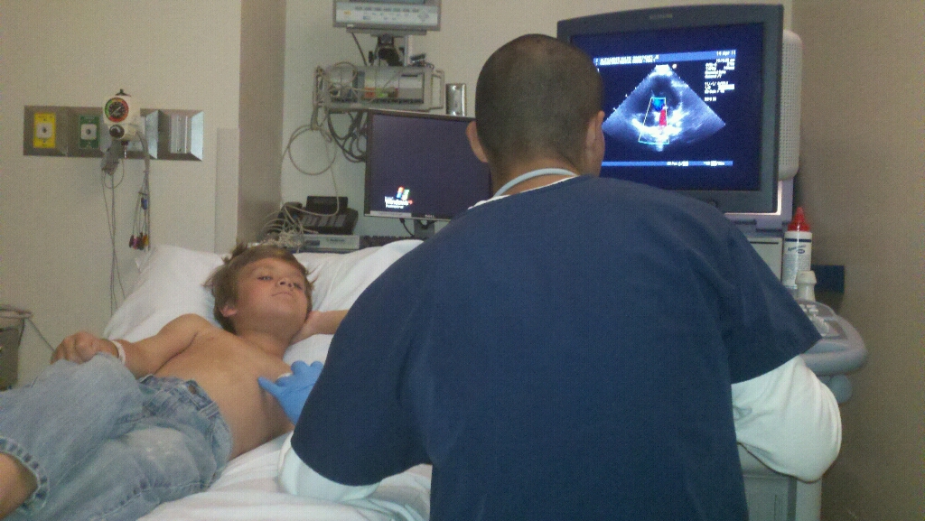 Image showing a medical staff performing a echocardiography on a pediatric patient