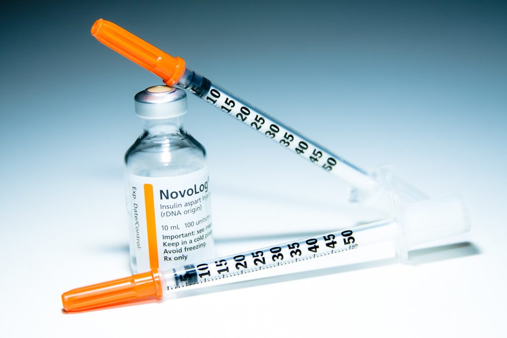 Image showing an Insulin Vial and two Insulin Syringes