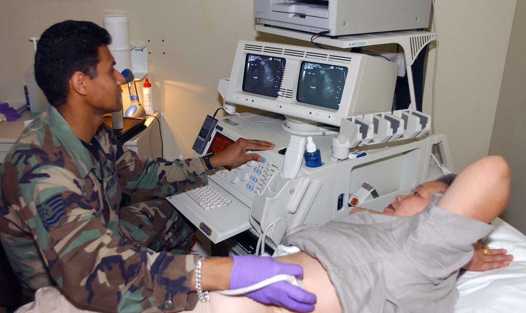 US Air Force (USAF) Technical Sergeant (TSGT) Thomas Peterson, Ultrasound Technologist, 31st Medical Group (MG), performs an abdominal ultrasound on a patient inside the hospital at Aviano Air Base (AB), Italy.