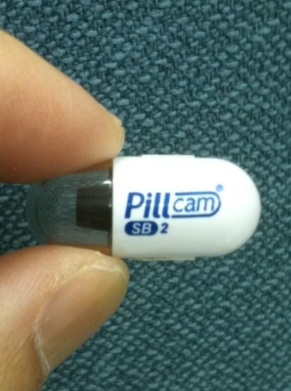 Image showing fingers holding a Pill Camera Used in a Capsule Endoscopy