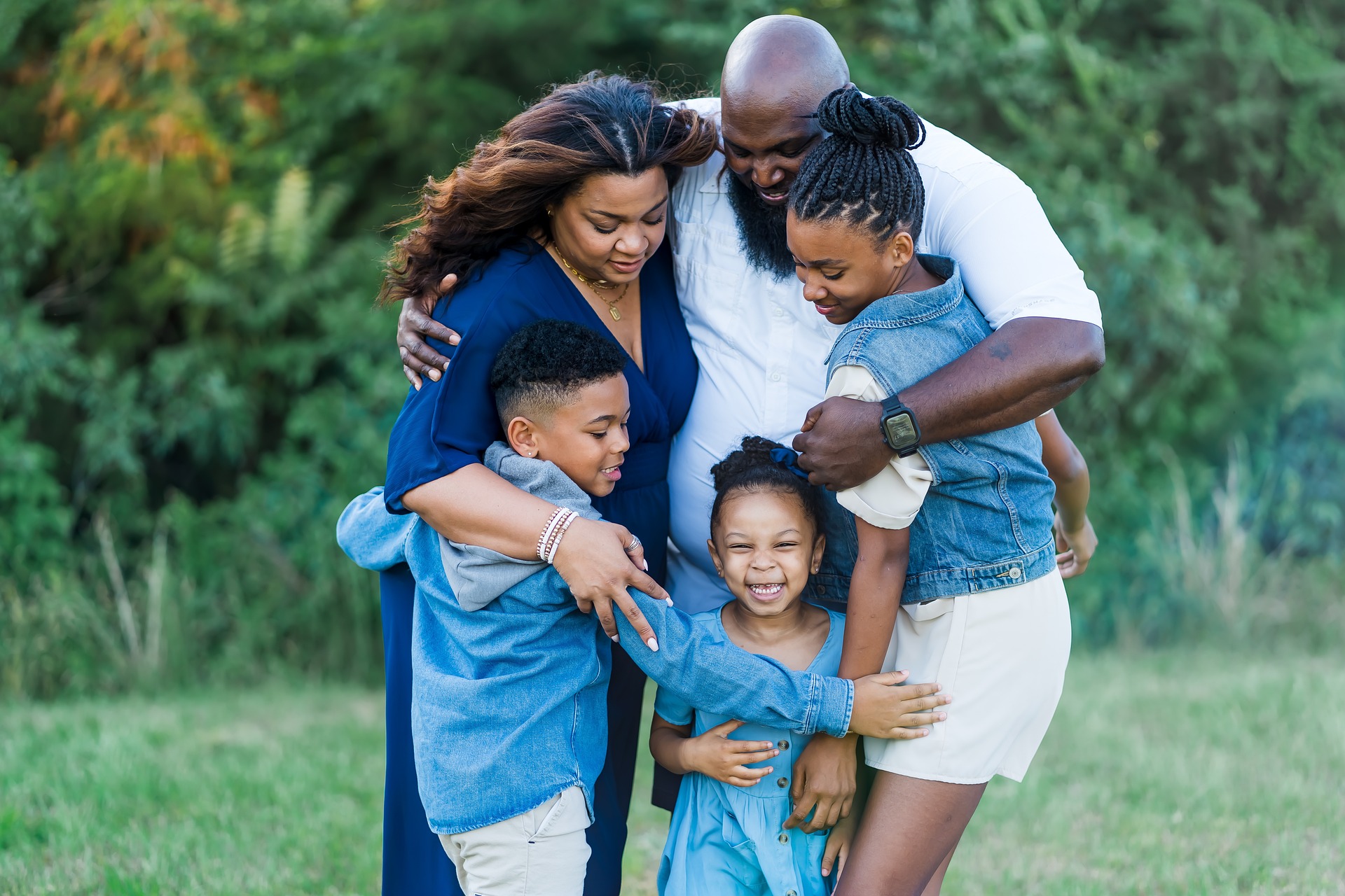 Image showing a family huddled together in a group hug