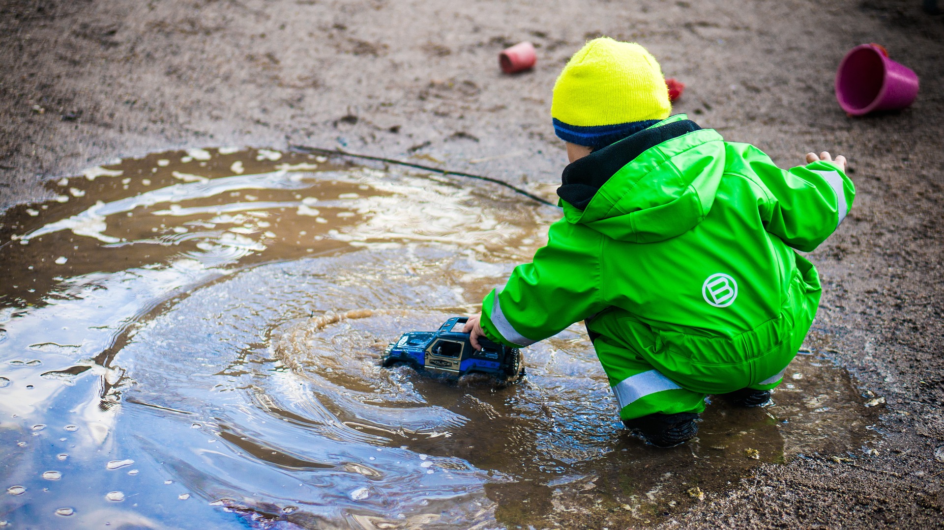 Image showing a Child Playing Independently in a puddle