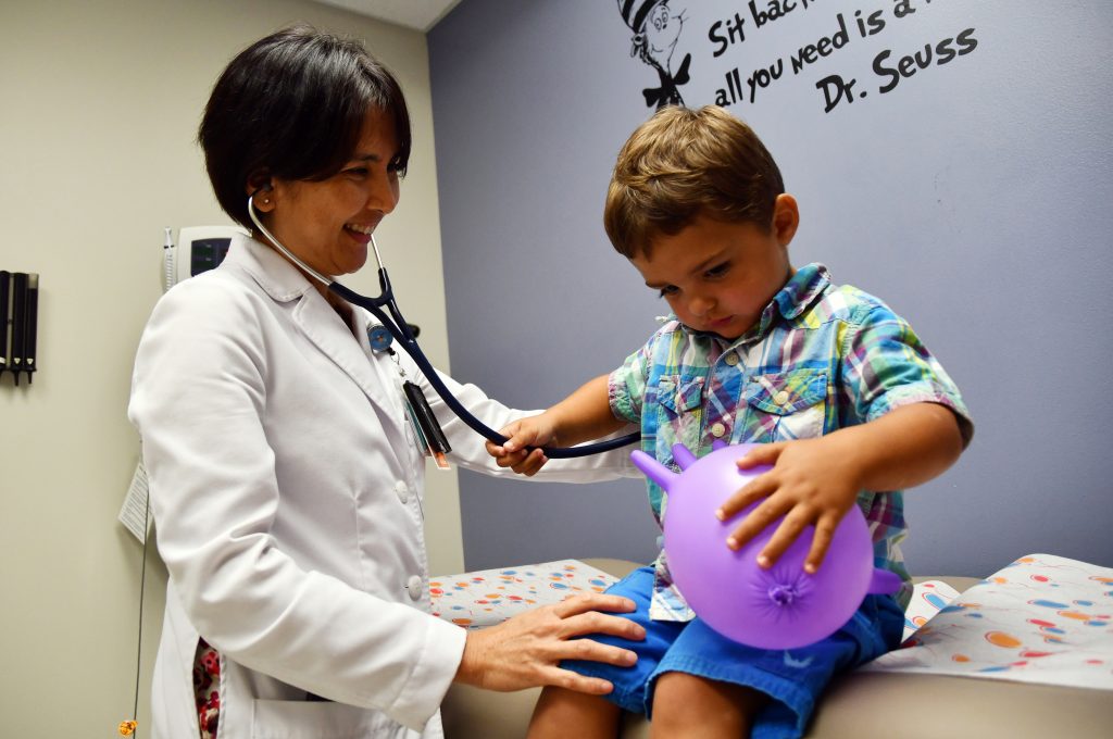 Dr. Ruby Tan listens with stethoscope on two-year-old patient Nolon McCollough in Pediatrics, Kenner Army Health Clinic, Fort Lee, Va., during a physical exam July 29 2019 (Photo by Lesley Atkinson, KAHC, PAO)