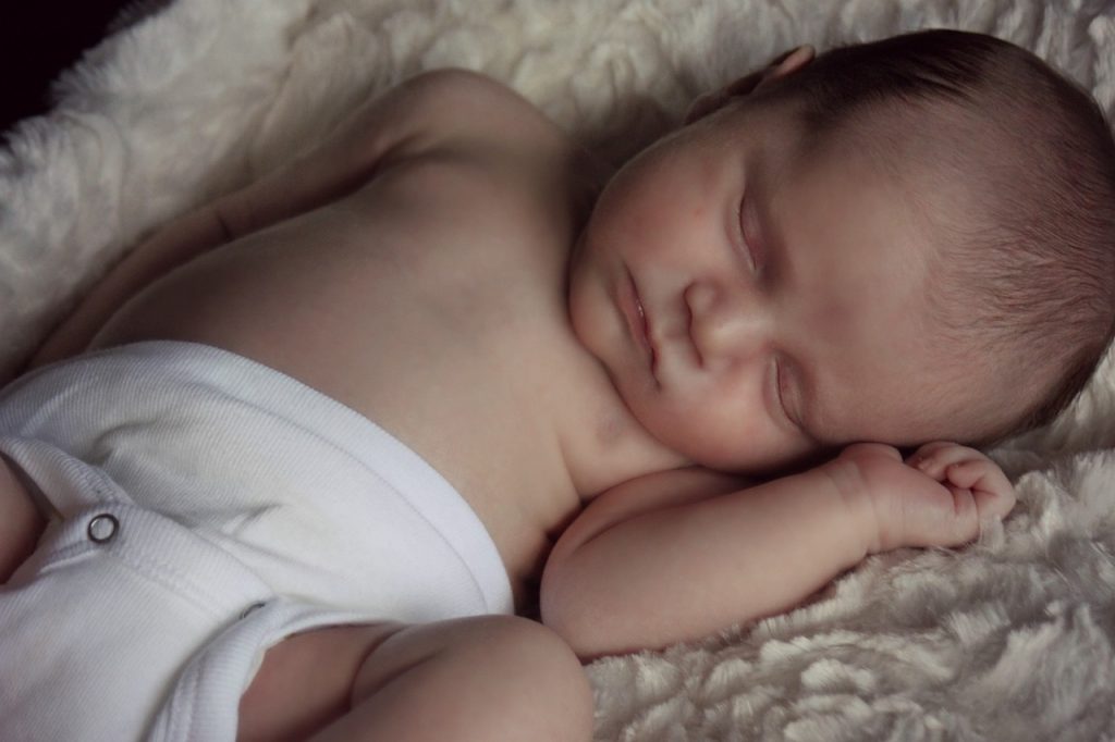 Photo showing a sleeping newborn in a cloth diaper