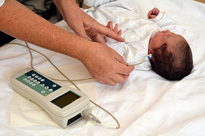 Phot showing an infant undergoing a hearing screening