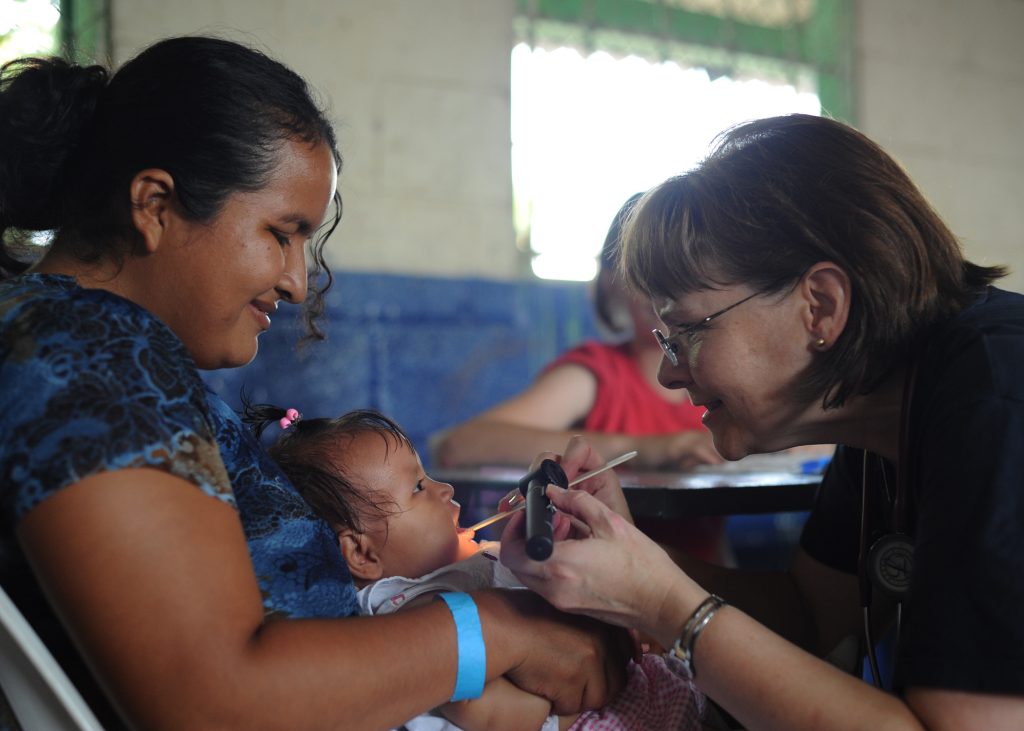 Cmdr. Karen Elgin examines a pediatrics patient during a Continuing Promise 2011 medical community service event at the Los Angeles medical site in Puerto San Jose, Guatemala