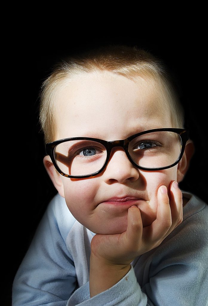 Photo showing a young child wearing glasses