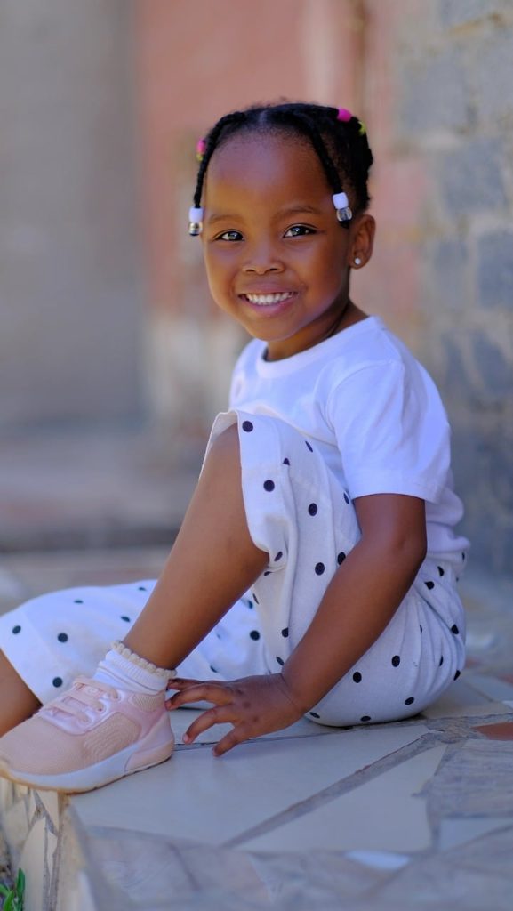 Photo showing a young child smiling at the viewer