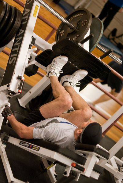 ”Leg_press” by bozdoz is licensed under CC BY 2.0 A person is using a leg press