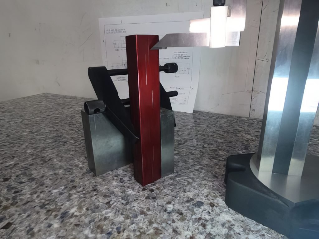 An angle plate is used to secure the part for a vertical layout