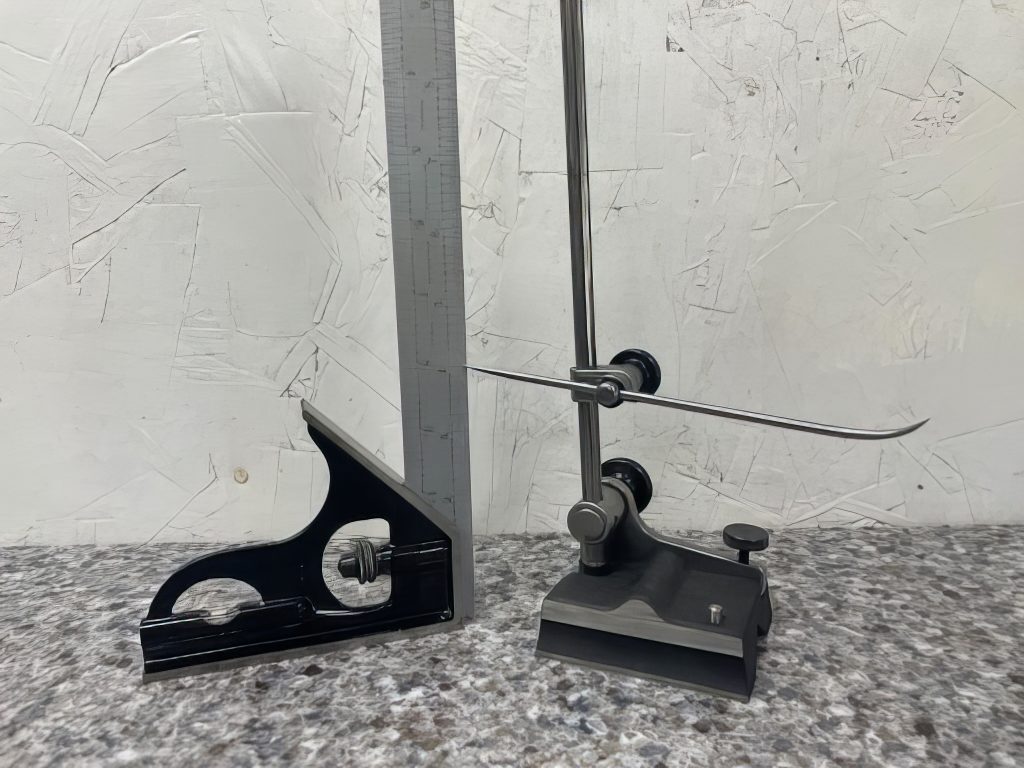 A surface gage is set to a height measurement for scribing