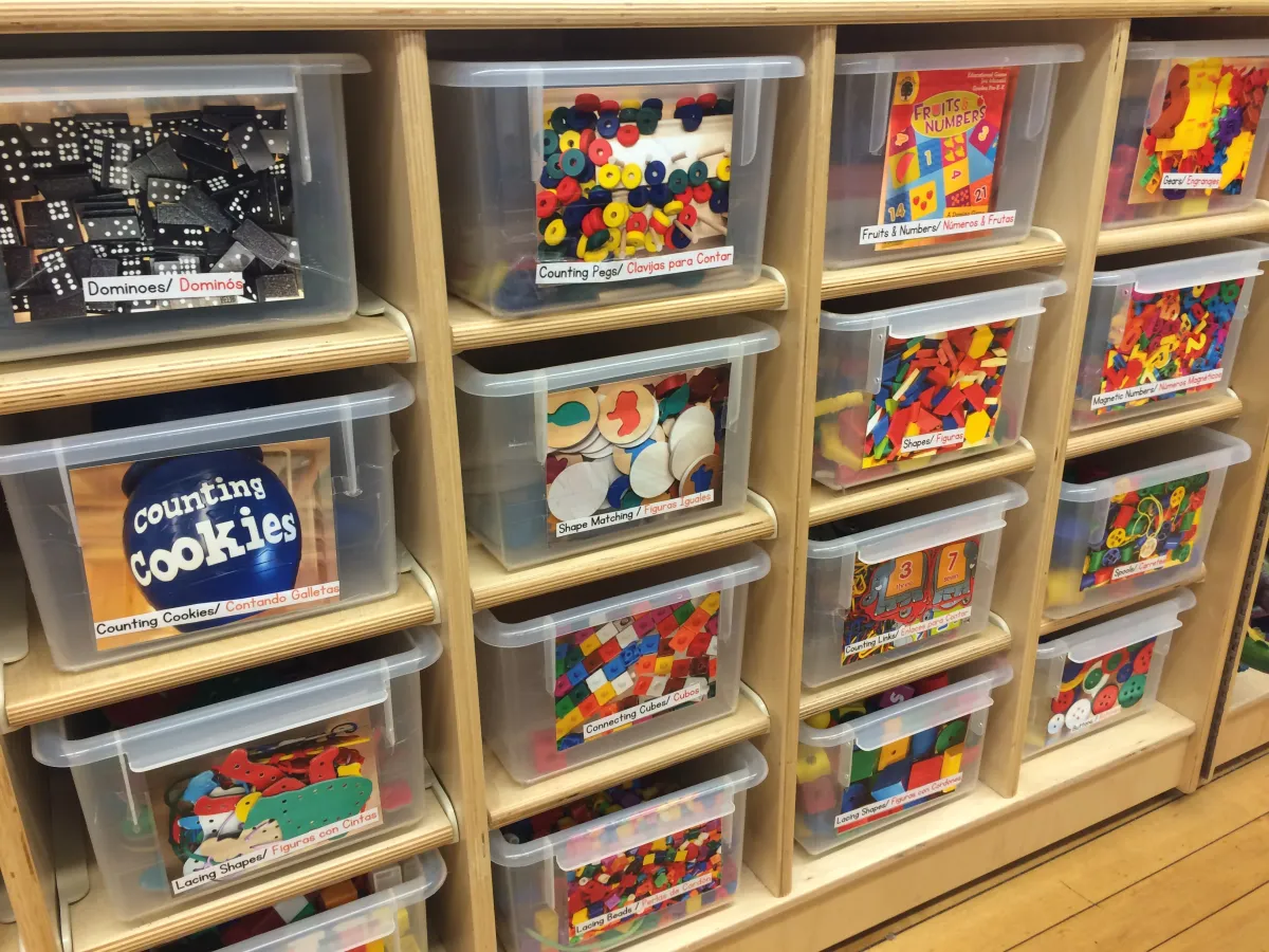 "IMG_4303.jpg" by Cinthya Quintana-Marofske, https://artofprek.com/ is used with permission. Plastic storage totes with bilingual labels and pictures of contents