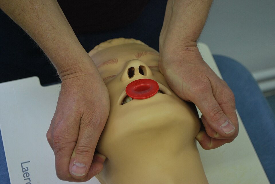 A demonstration of the jaw thrust maneuver on a simulated patient